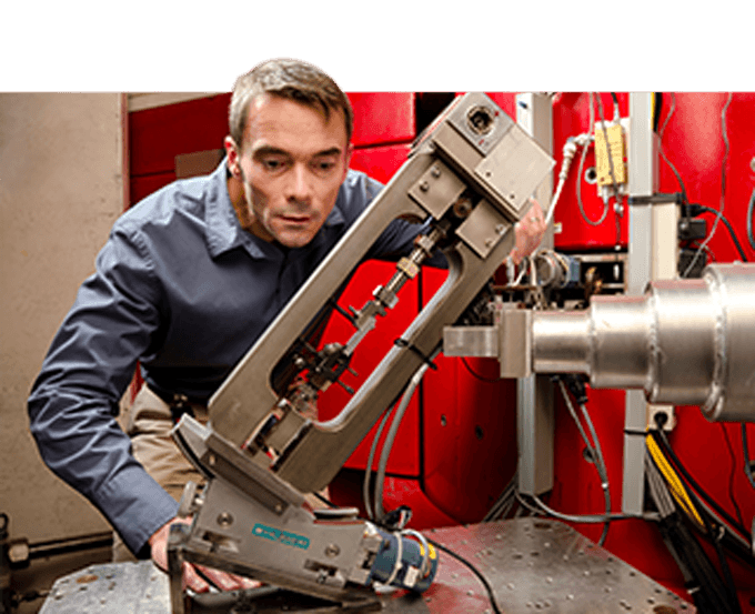 Man in collared shirt with piece of scientific equipment